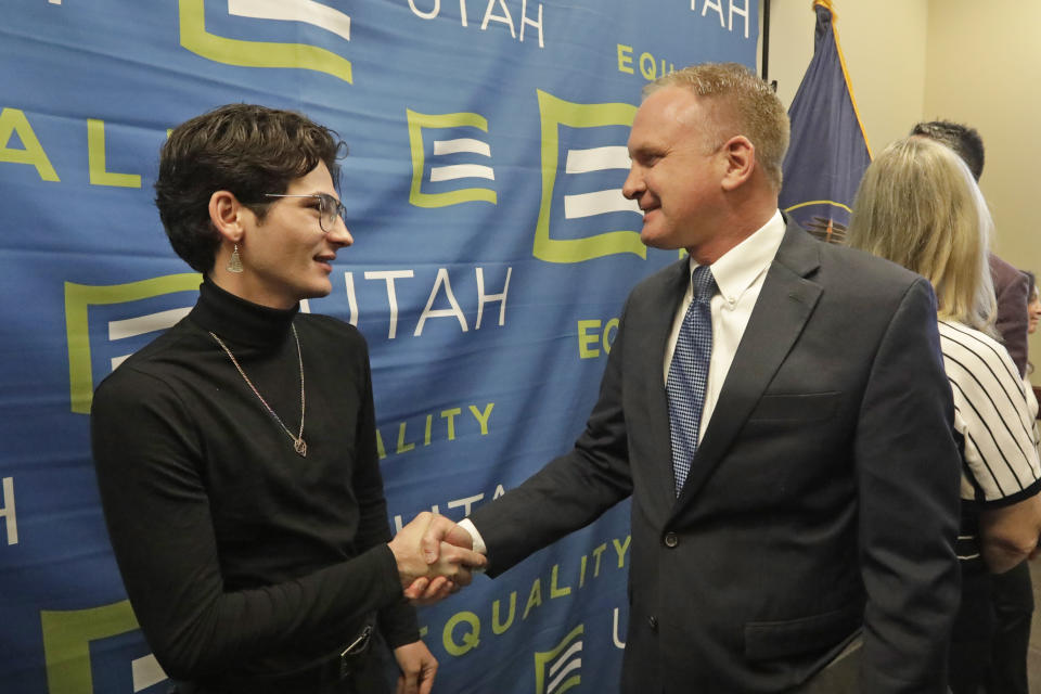 Nathan Dalley, left, shakes hands with Republican Utah Rep. Craig Hall following a news conference about the discredited practice of conversion therapy for LGBTQ children, now banned in Utah Wednesday, Jan. 22, 2020, at the Utah State Capitol, in Salt Lake City. Dalley under went so-called conversion therapy. (AP Photo/Rick Bowmer)