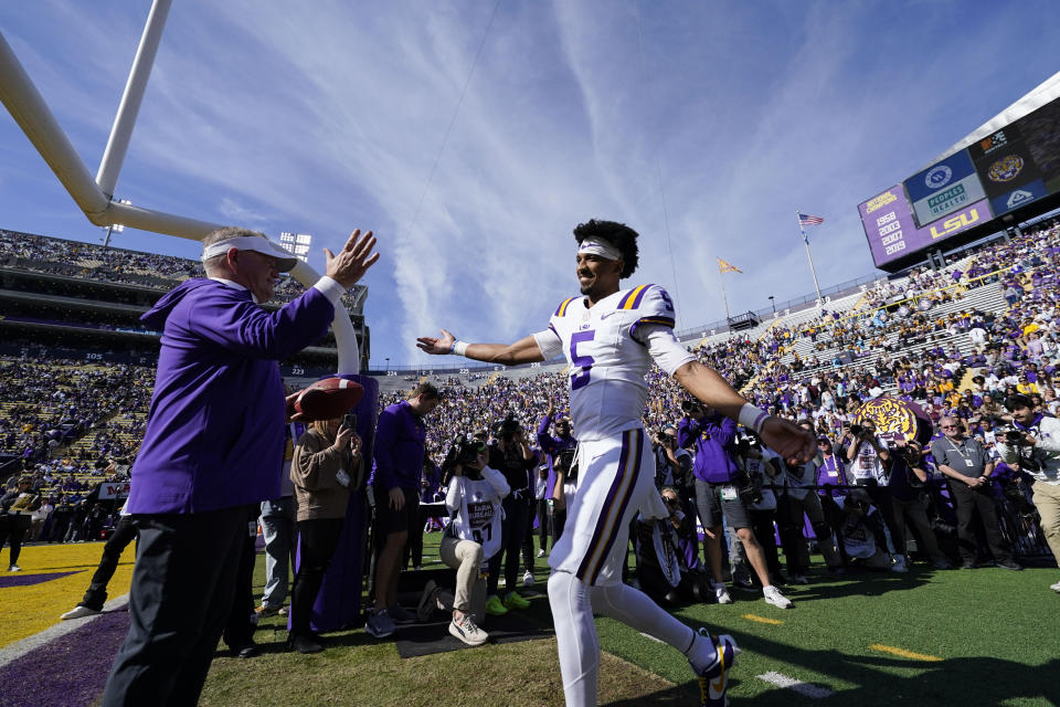 LSU head coach Brian Kelly greets LSU quarterback Jayden Daniels (5) as the school honors senior players on senior day, before an NCAA college football game against Texas A&M in Baton Rouge, La., Saturday, Nov. 25, 2023. (AP Photo/Gerald Herbert)