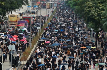 Anti-government demonstrators march in protest against the invocation of the emergency laws in Hong Kong