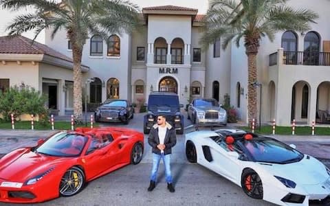 Mohammad Makhlouf, 22, flaunts the wealth of his family outside the Dubai mansion bearing his initials.  - Credit: Instagram