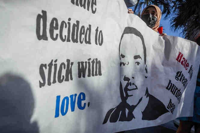 Nova Southeastern University students from the Student National Medical Association carried signage in the parade along North Federal Highway during a Martin Luther King, Jr., Day parade in Boca Raton, Fla., on Monday, January 17, 2022.