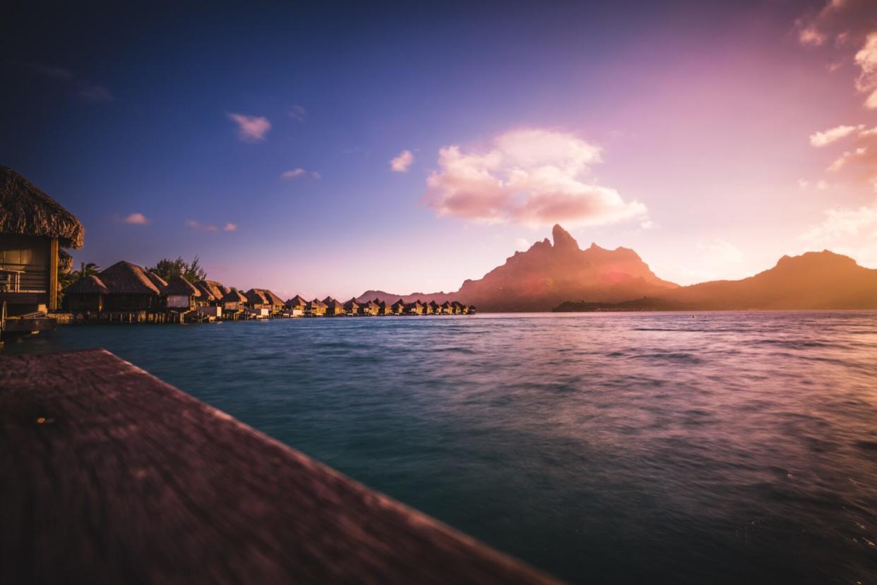 Due to the gorgeous setting of the film "Couples Retreat" many viewers wonder where was "Couples Retreat" filmed. pictured: Bora Bora at sunset overlooking the water and mountain view