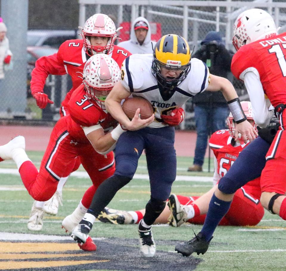 Tioga quarterback Caden Bellis carries the ball as Randolph's Xander Hind goes for the tackle during the Tigers' 41-34 win in a NYSPHSAA Class D semifinal Nov. 25, 2022 at Union-Endicott.