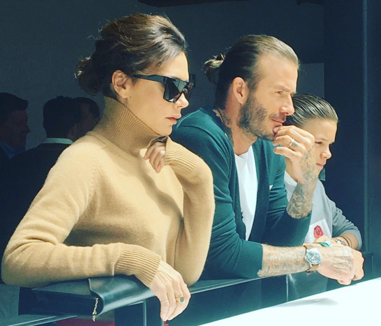 Victoria, David and Romeo Beckham watch the Kent & Curwen presentation [Photo: Instagram/@gurd_loyal]