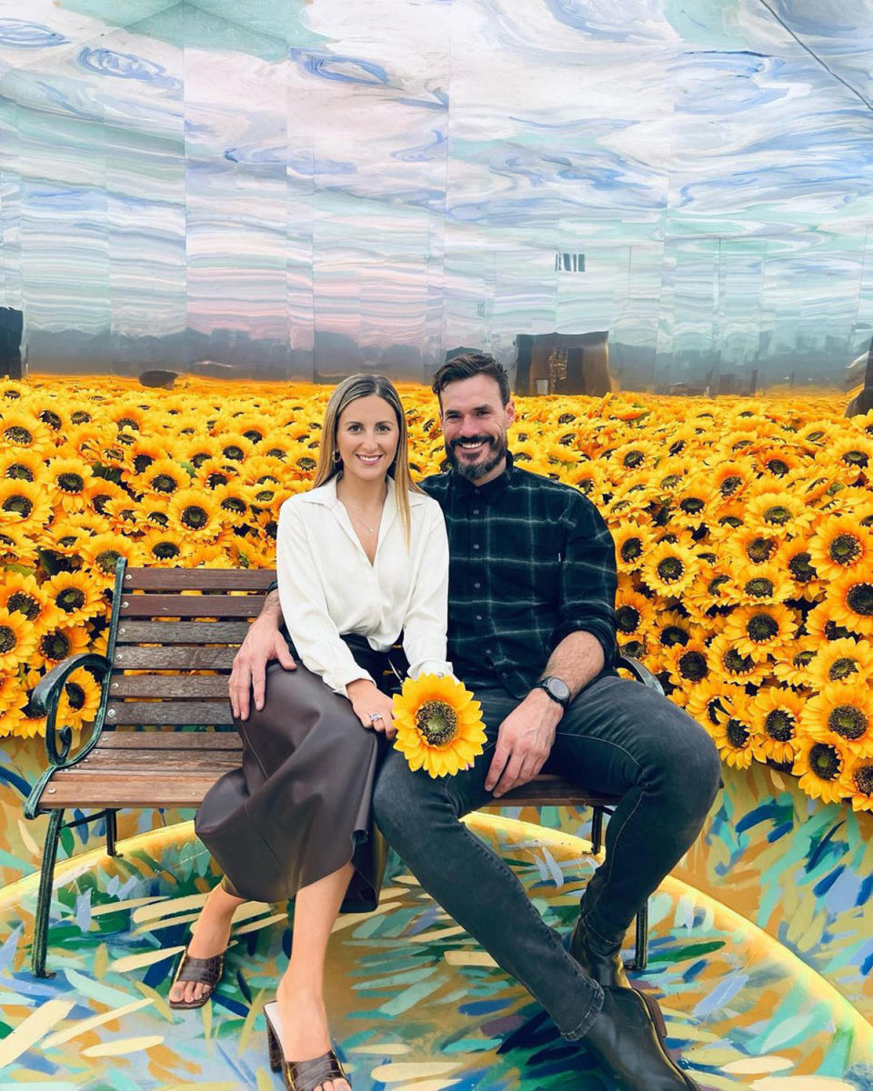 Irena and Locky posing in front of sunflowers