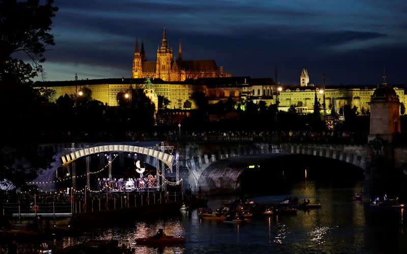 People watch a classical concert on a floating stage in Prague