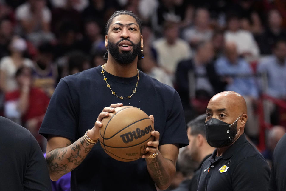 Los Angeles Lakers forward Anthony Davis watches from the bench during the first half of an NBA basketball game against the Miami Heat, Wednesday, Dec. 28, 2022, in Miami. (AP Photo/Lynne Sladky)