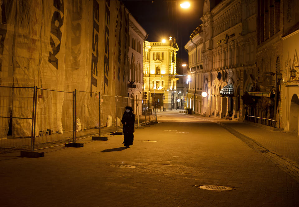 A nun wearing face masks to protect against coronavirus, walks on an empty street in Old Town in Vilnius, Lithuania, Saturday, April 18, 2020. For Orthodox Christians, this is normally a time of reflection, communal mourning and joyful release, of centuries-old ceremonies steeped in symbolism and tradition. But this year, Easter - by far the most significant religious holiday for the world's roughly 300 million Orthodox - has essentially been cancelled. (AP Photo/Mindaugas Kulbis)