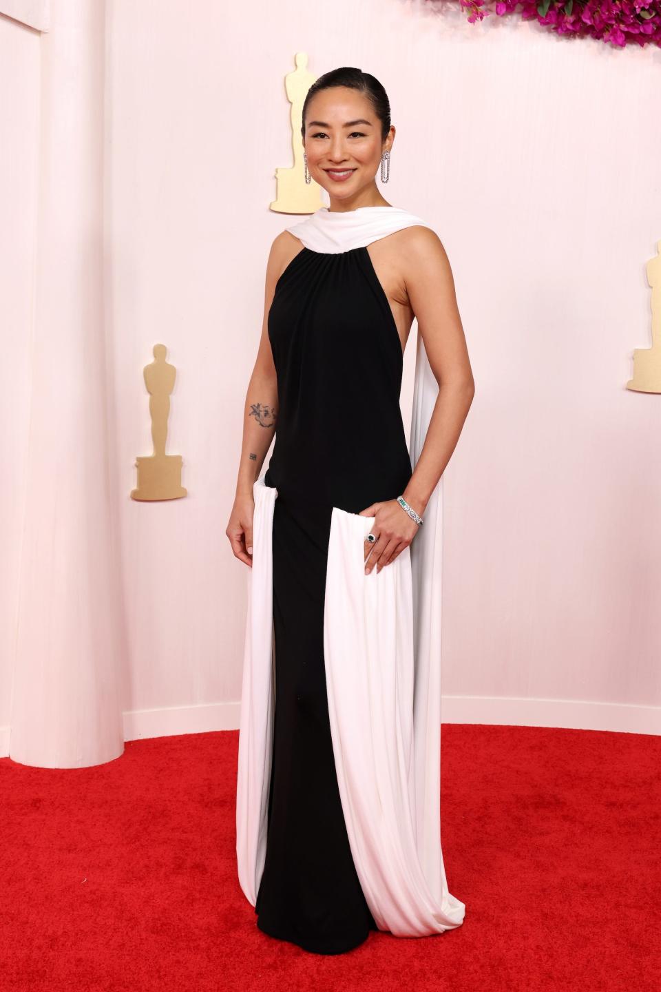 Greta Lee attends the 2024 Oscars.