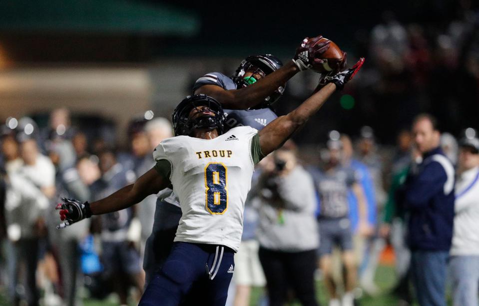 Benedictine receiver La'don Bryant makes a catch over Troup County's Jay Young during the Class 4A state semifinal game Friday night at Memorial Stadium.