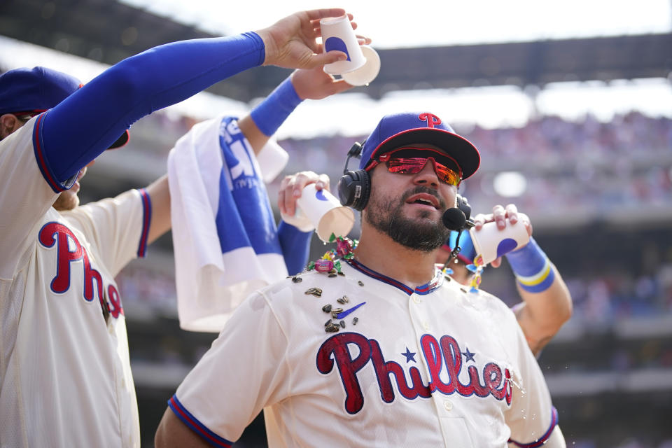 Philadelphia Phillies' Kyle Schwarber, right, has water and snacks poured on him after the Phillies won a baseball game against the Kansas City Royals, Sunday, Aug. 6, 2023, in Philadelphia. (AP Photo/Matt Slocum)