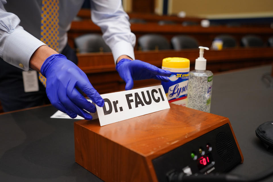 FILE - A name plate for Director of the National Institute of Allergy and Infectious Diseases Dr. Anthony Fauci is placed before a House Committee on Energy and Commerce on the Trump administration's response to the COVID-19 pandemic on Capitol Hill in Washington on June 23, 2020. Fauci steps down from a five-decade career in public service at the end of the month, one shaped by the HIV pandemic early on and the COVID-19 pandemic at the end. (Kevin Dietsch/Pool via AP, File)