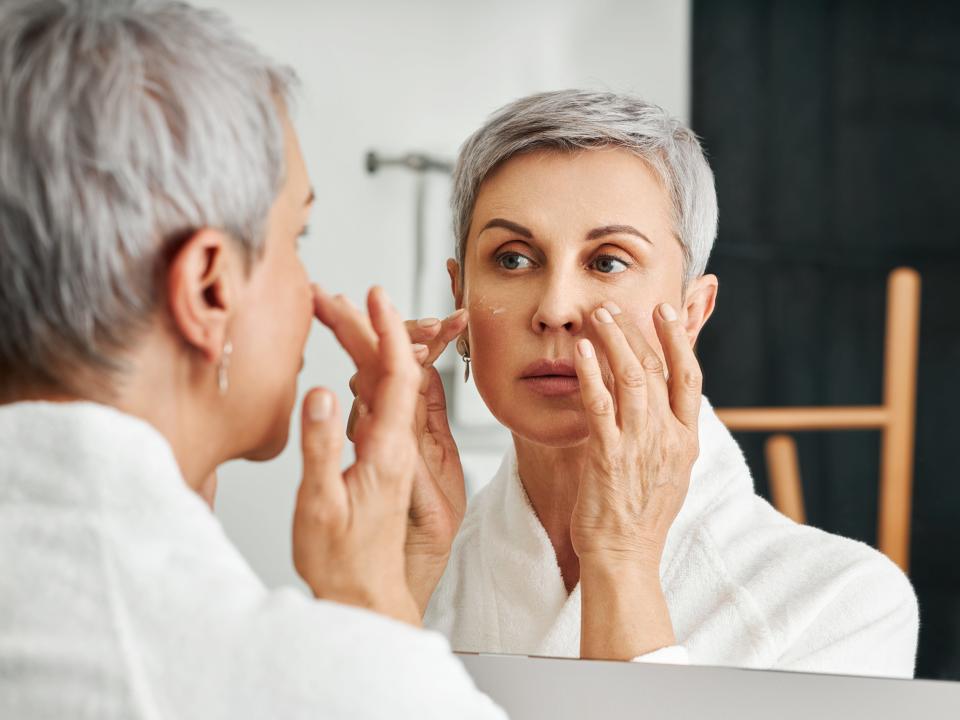 A woman applying night cream