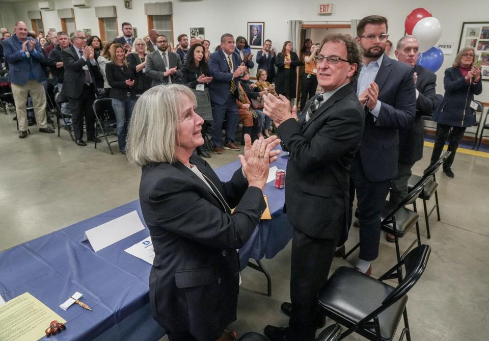 From left, Rhode Island Democratic state committee officers Ann Gooding, James Ginalfi, Thomas Kane and Stephen Mulcahey applaud Elizabeth Beretta-Perik after she was elected chair Wednesday night in East Providence.