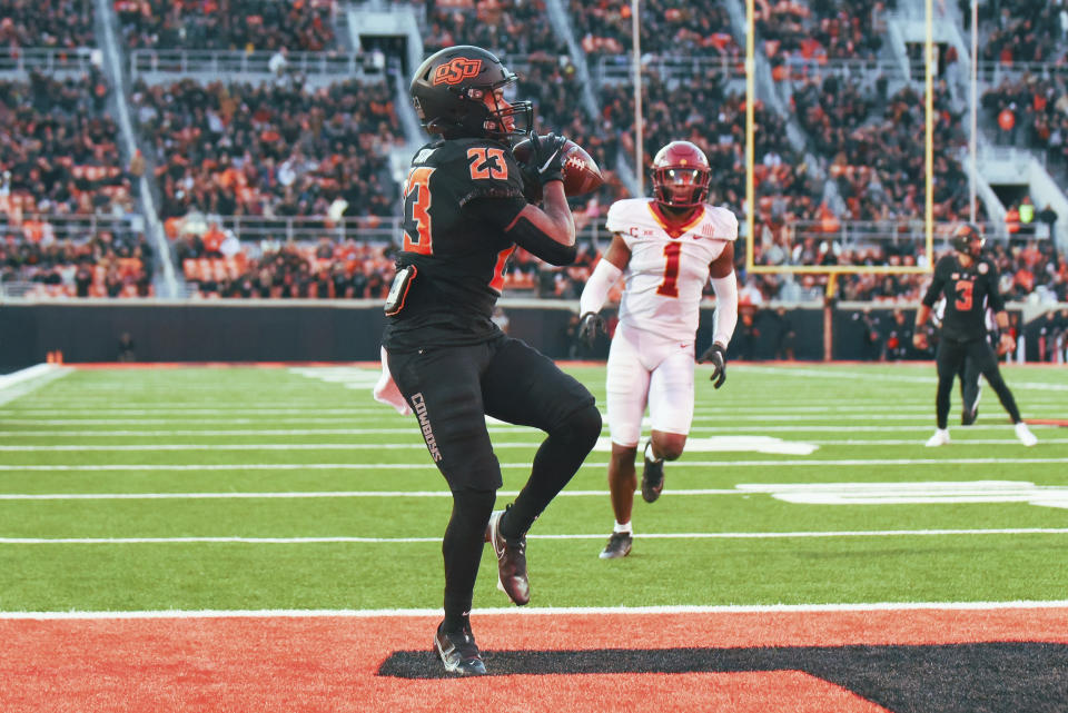 Iowa State defensive back Anthony Johnson Jr. (1) watches as Oklahoma State running back Jaden Nixon (23) catches the winning touchdown pass from Oklahoma State quarterback Spencer Sanders (3) during the second half of an NCAA college football game Saturday, Nov. 12, 2022, in Stillwater, Okla. (AP Photo/Brody Schmidt)