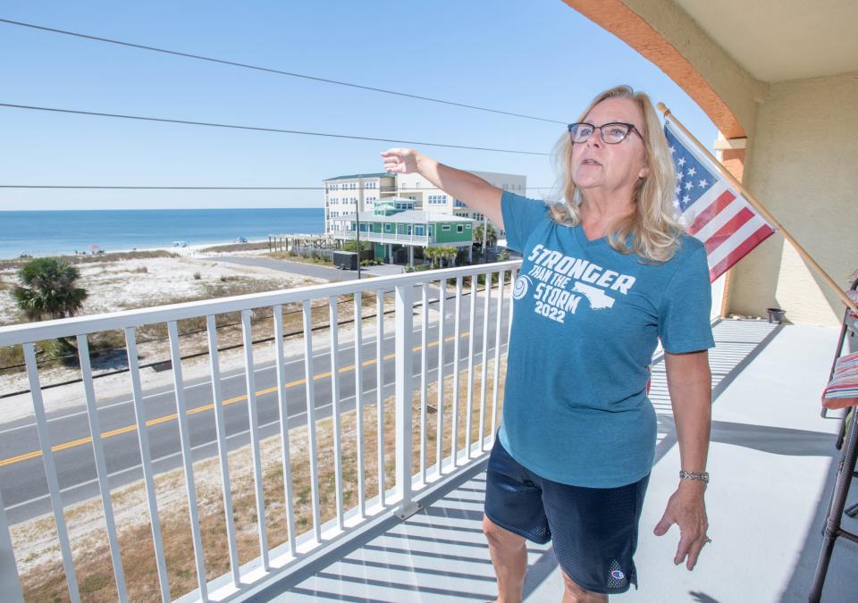 Rose Young points out the empty lot across U.S. 98 from her condo in Mexico Beach. The houses that once stood on that property were destroyed, along with many other buildings in the area, when Hurricane Michael hit in October 2018.