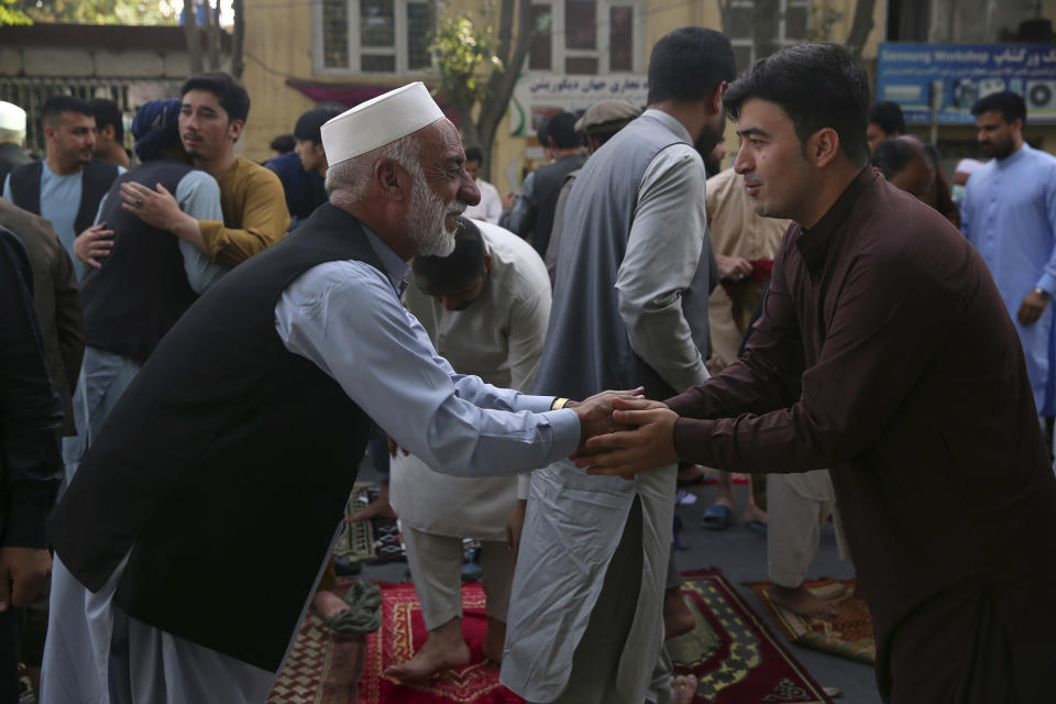 Afghan Muslims greet each other after offering Eid al-Adha prayers in Kabul, Afghanistan, Friday, July 31, 2020. During the Eid al-Adha, or Feast of Sacrifice, Muslims slaughter sheep or cattle and distribute portions of the meat to the poor. (AP Photo/Rahmat Gul)