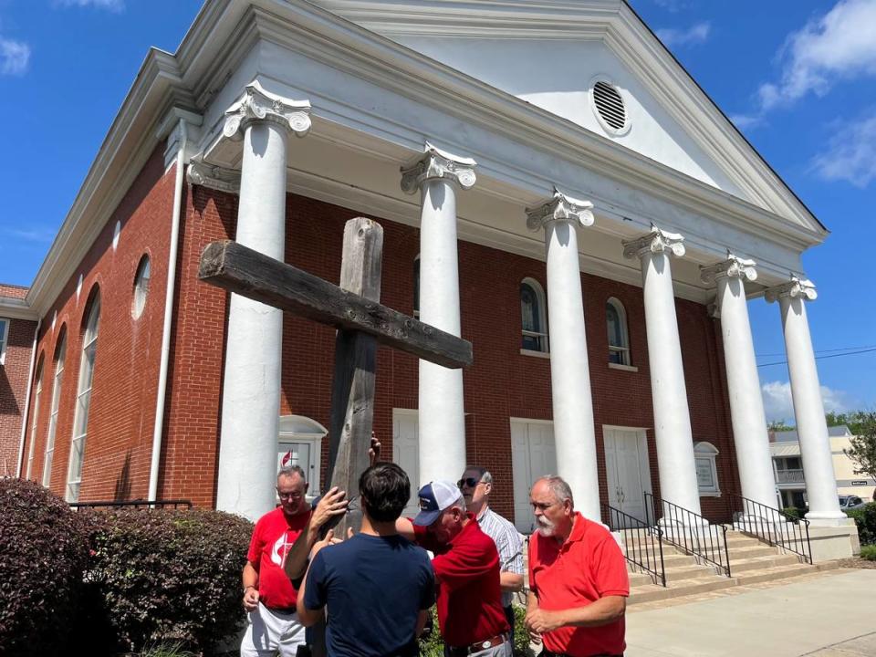 A cross is placed upright in a hole at United Methodist Church on Carteret Street in Beaufort after members carried it about 2 miles through the city in commemoration of Good Friday.
