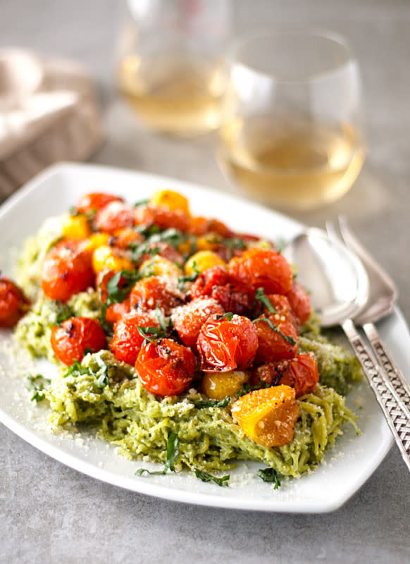 <p>A Happy Food Dance</p><p>This homemade garlicky pesto spaghetti squash is topped with yellow and red roasted tomatoes, the perfect low calorie alternative to a large bowl of pasta!</p><p><a href="http://ahappyfooddance.com/pesto-spaghetti-squash-roasted-tomatoes/" rel="nofollow noopener" target="_blank" data-ylk="slk:Get the recipe here!;elm:context_link;itc:0;sec:content-canvas" class="link rapid-noclick-resp"><em><strong>Get the recipe here!</strong></em></a></p>