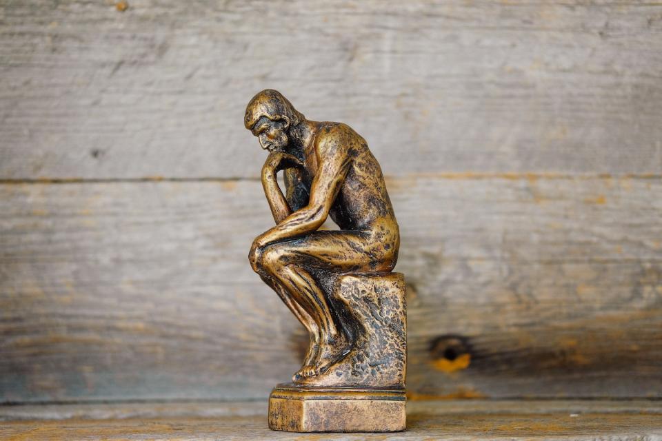 a miniature version of Rodin's "The Thinker" sculpture