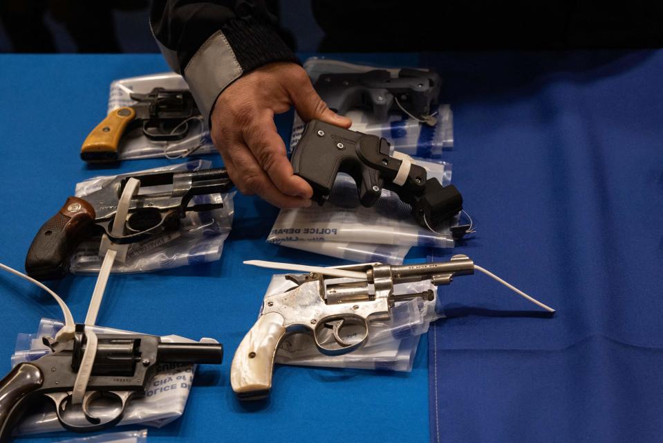 Kings County District Attorney Eric Gonzalez holds a 3D printed ghost gun during a statewide gun buyback event held by the office of the New York State Attorney General, in the Brooklyn borough of New York on April 29, 2023.