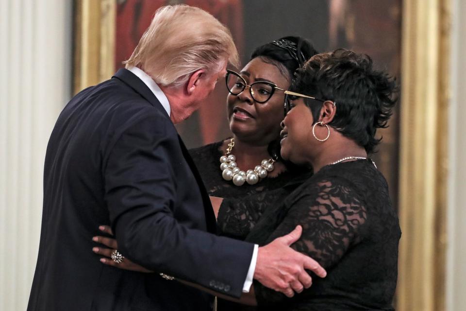 President Donald Trump hugs conservative social media figure Rochelle Richardson, known as Silk of "Diamond and Silk" as she and Lynnette Hardaway, known as Diamond, come on to the stage at the president's invitation at his social media summit with prominent conservative social media figures on July 11, 2019 in Washington, DC.