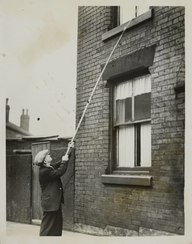 a knocker-up banging on a window