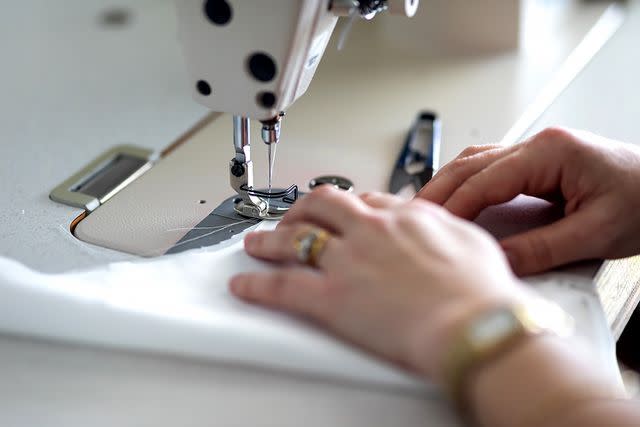 <p>Getty</p> Stock image of seamstress altering dress