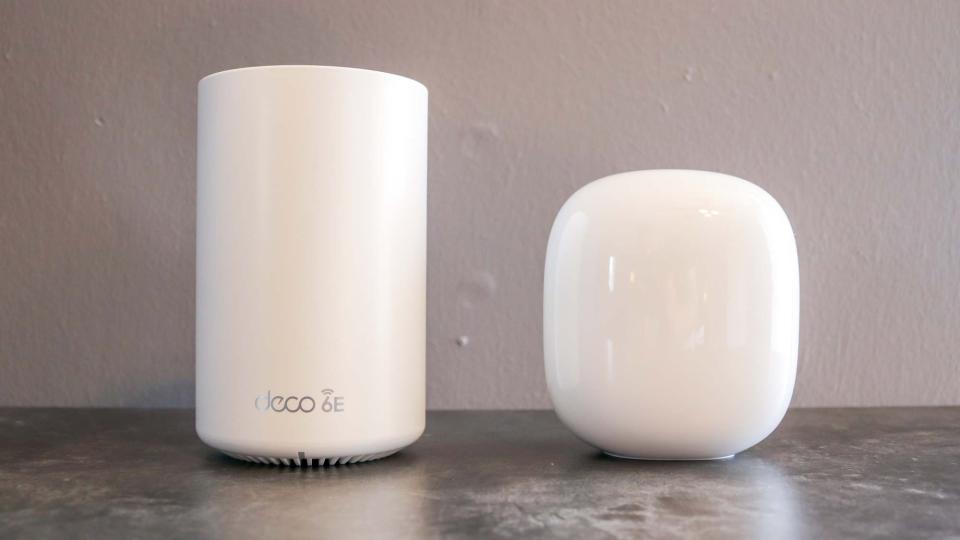 A Nest Wifi Pro next to a TP-Link Deco XE75