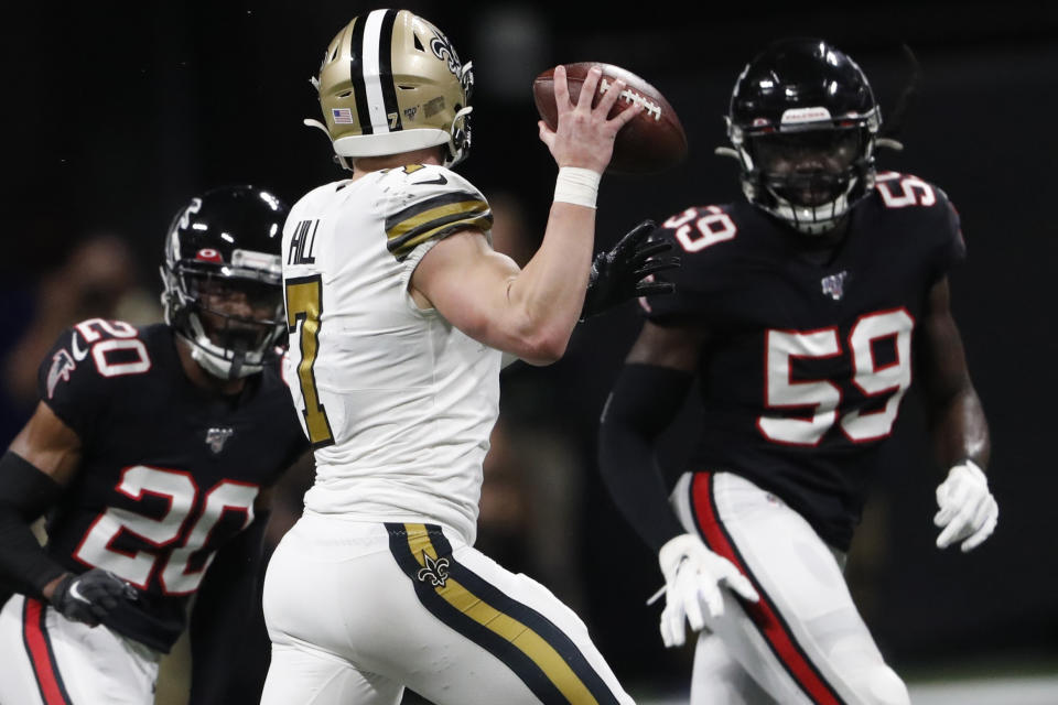 New Orleans Saints quarterback Taysom Hill (7) passes against Atlanta Falcons defensive back Kendall Sheffield (20) and Atlanta Falcons outside linebacker De'Vondre Campbell (59) during the second half of an NFL football game, Thursday, Nov. 28, 2019, in Atlanta. (AP Photo/John Bazemore)