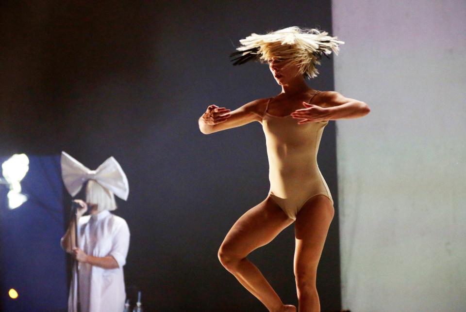 Sia and Maddie Ziegler perform on stage together. (Credit: REX)