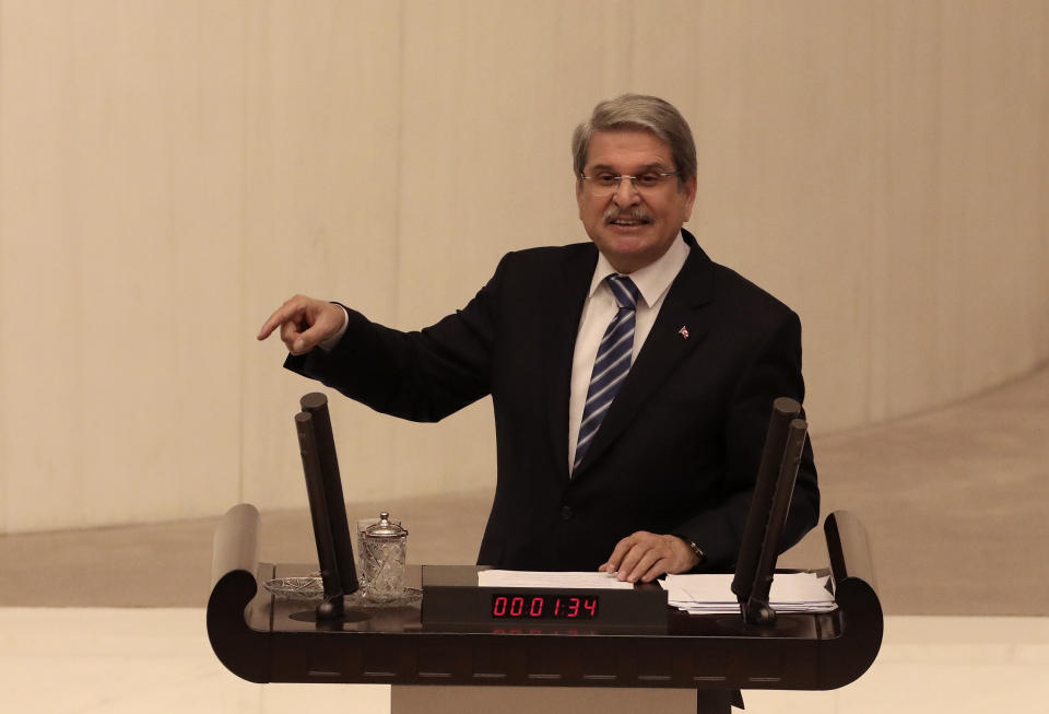 Aytun Ciray, a lawmaker of the opposition nationalist IYI "Good" Party, speaks before Turkey's parliament authorized the deployment of troops to Libya to support the U.N.-backed government in Tripoli battle forces loyal to a rival government that is seeking to capture the capital, in Ankara, Turkey, Thursday, Jan. 2, 2020. Turkish lawmakers voted 325-184 at an emergency session in favor of a one-year mandate allowing the government to dispatch troops amid concerns that Turkish forces could aggravate the conflict in Libya and destabilize the region.(AP Photo/Burhan Ozbilici)