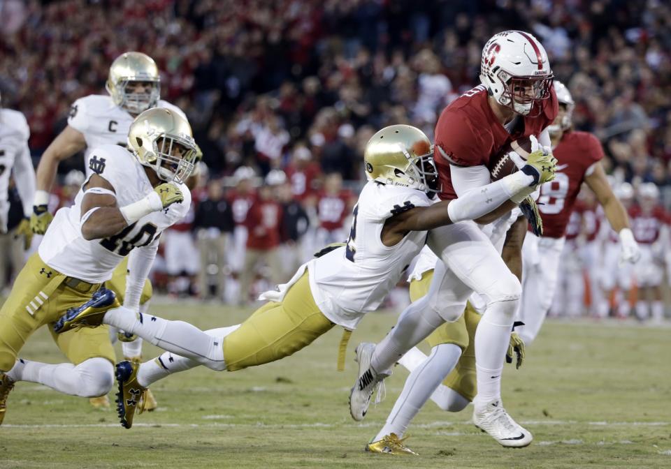 Stanford tight end Dalton Schultz (9) is tackled by Notre Dame cornerback Devin Butler during the first half of an NCAA college football game Saturday, Nov. 28, 2015, in Stanford, Calif. (AP Photo/Marcio Jose Sanchez)