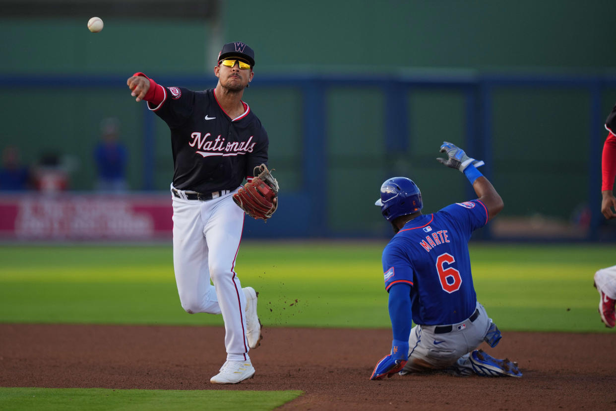 Trey Lipscomb (38) turns a double-play during a spring training game for the Nationals.