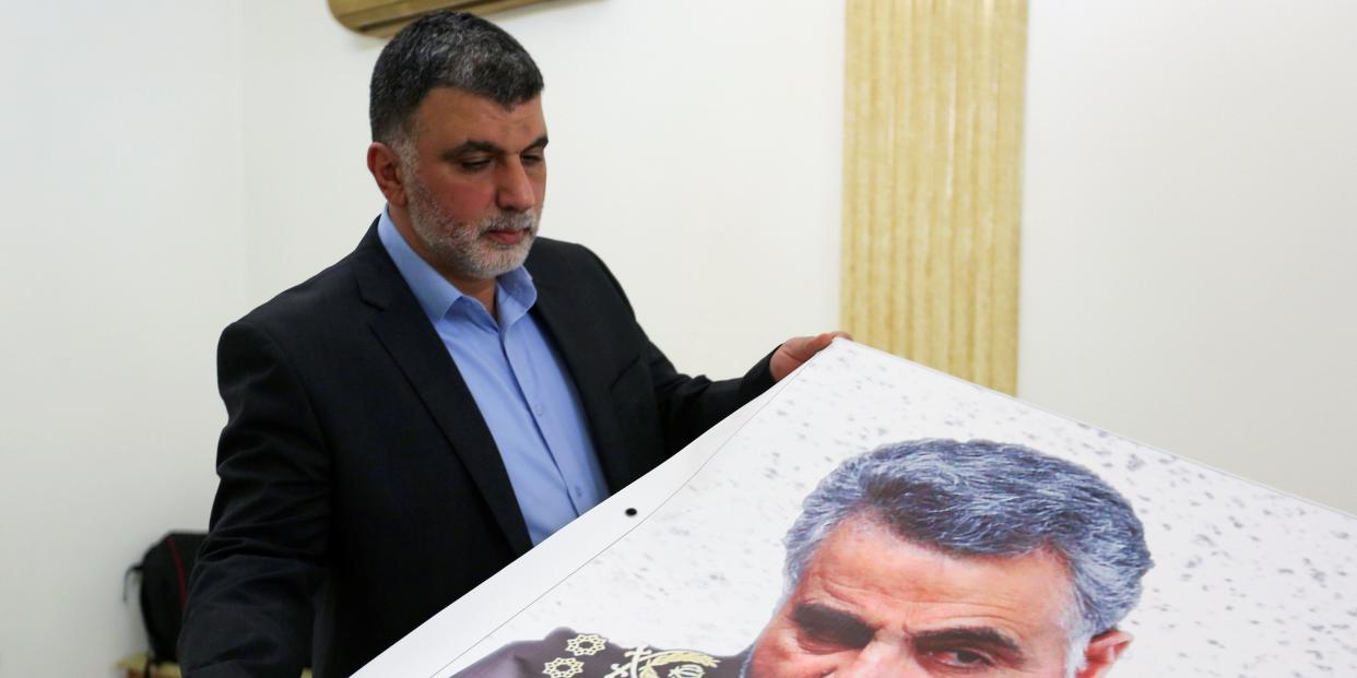 A man holds a banner depicting late Major-General Qassem Soleimani, head of the elite Quds Force, who was killed in a U.S. airstrike Near Baghdad, at the Iranian embassy in Beirut, Lebanon January 3, 2020. REUTERS/Aziz Taher