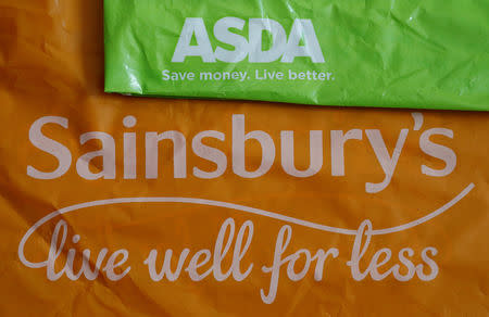 FILE PHOTO: Shopping bags from Asda and Sainsbury's are seen in Manchester, Britain April 30, 2018. REUTERS/Phil Noble/illustration/File Photo