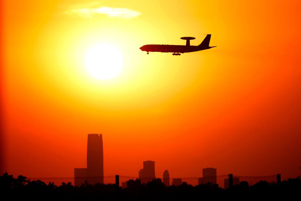An AWAC flies by the Oklahoma City skyline during sunset, Friday, Aug., 25, 2023.