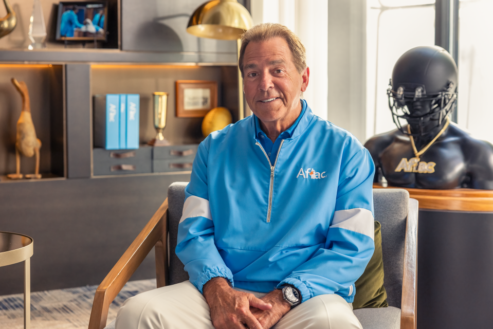 Alabama coach Nick Saban poses for a photo on the set of filming a commercial for Aflac.