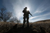 FILE - A National Guards soldier stands guard near Bavispe, Sonora state, Mexico, where family members of the extended LeBaron family were ambushed by gunmen last year, one day before the expected arrival of Mexican President Andres Manuel Lopez Obrador, Jan. 11, 2020. Lopez Obrador has begun exploring plans to side-step congress to hand formal control of the National Guard to the army. That has raised concerns, because he won approval for creating the force in 2019 by pledging in the constitution that it would be under nominal civilian control and that the army would be off the streets by 2024. (AP Photo/Christian Chavez, File)