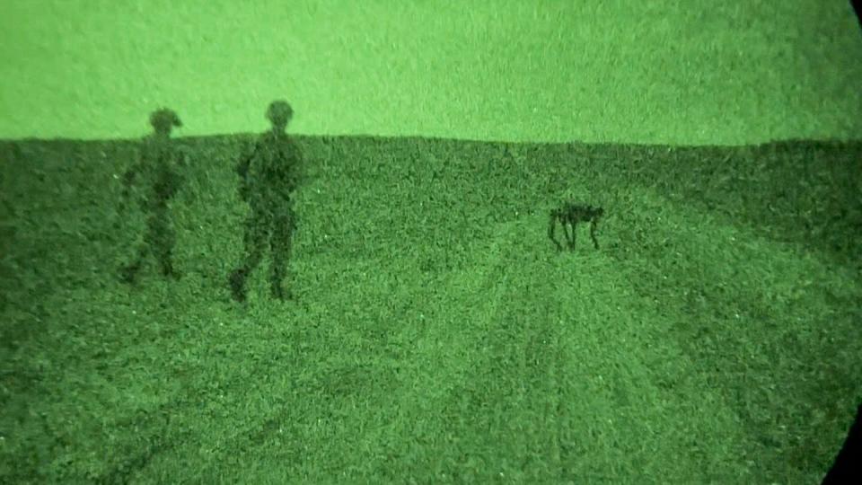 U.S. soldiers walk alongside a Ghost Robotics-made Vision 60 quadruped unmanned ground vehicle at Fort Liberty, N.C., on Aug. 14, 2023. (Sgt. Jacob Moir/U.S. Army)