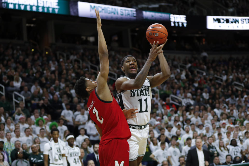 Michigan State forward Aaron Henry (11) shoots on Maryland guard Aaron Wiggins (2) in the second half of an NCAA college basketball game in East Lansing, Mich., Saturday, Feb. 15, 2020. (AP Photo/Paul Sancya)