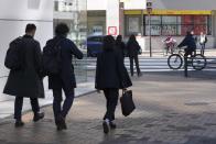 Person walk near an electronic stock board showing Japan's Nikkei 225 index at a securities firm Wednesday, March 27, 2024, in Tokyo. Asian shares were mixed on Wednesday after Wall Street slipped a bit further from its record highs. (AP Photo/Eugene Hoshiko)