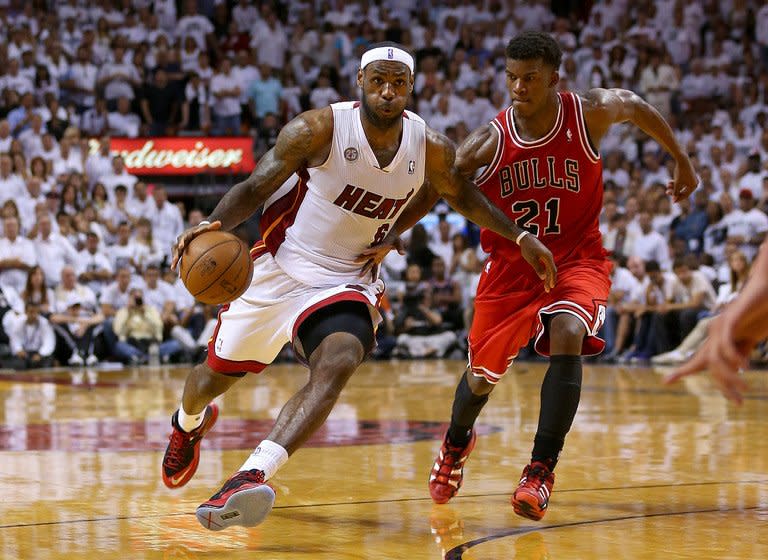 Miami Heat's LeBron James is guarded by Chicago Bulls' Jimmy Butler during their game in Miami on May 15, 2013. James finished with 23 points and eight assists as the Heat held on after blowing an 18-point lead to beat Chicago 94-91