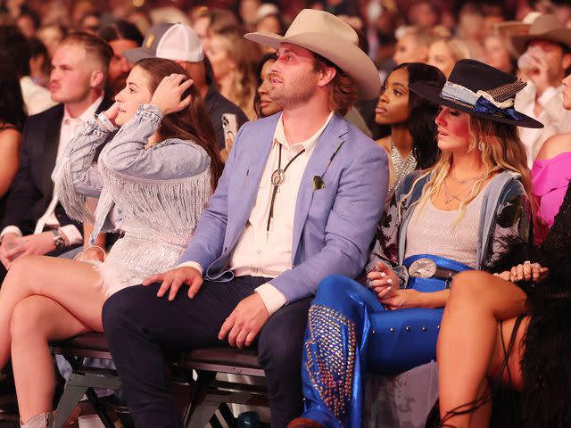 <p>Christopher Polk/Penske Media/Getty </p> Devlin Hodges and Lainey Wilson at the 58th Academy of Country Music Awards.