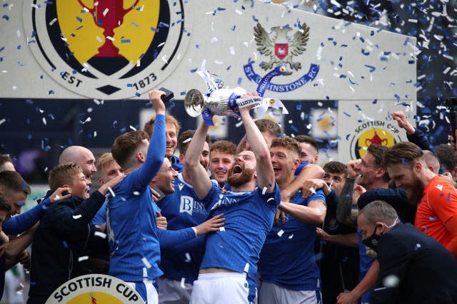 Shaun Rooney lifts the trophy