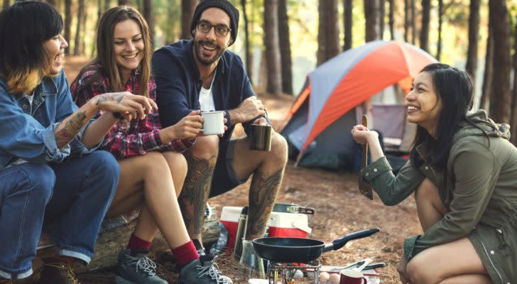 a couple has breakfast at a campsite