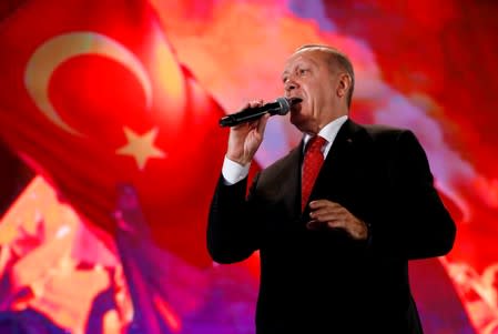 FILE PHOTO: Turkish President Erdogan addresses his supporters during a ceremony marking the third anniversary of the attempted coup at Ataturk Airport in Istanbul