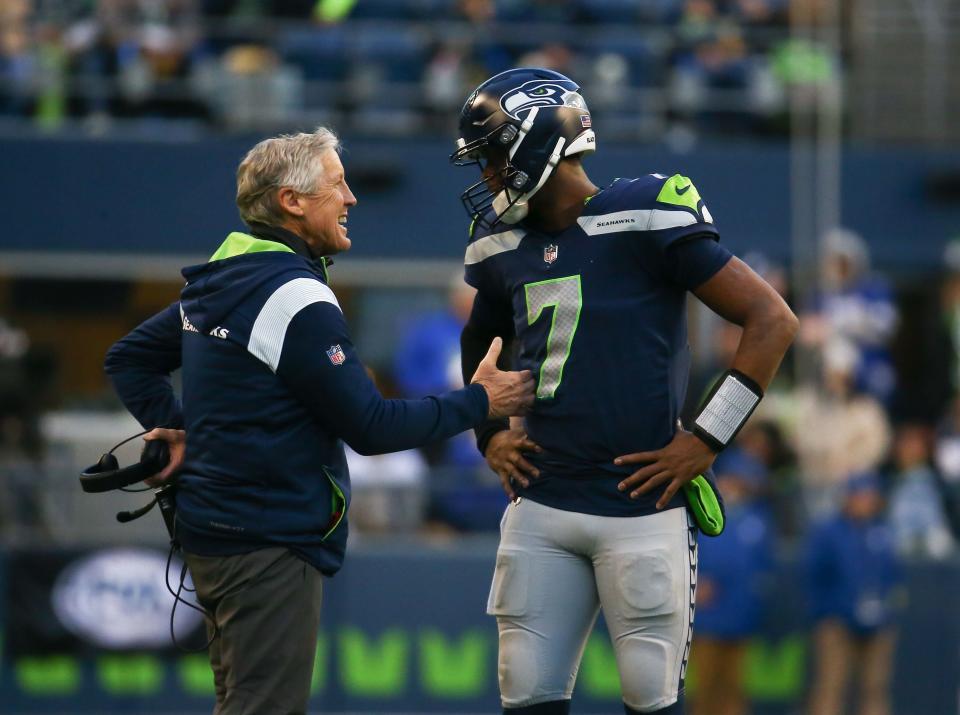 SEATTLE, WA - JANUARY 01:  Geno Smith #7 of the Seattle Seahawks talks with head coach Pete Carroll in between plays against the New York Jets during the second half of the game at Lumen Field on January 1, 2023 in Seattle, Washington. The Seahawks won 23-6.  (Photo by Lindsey Wasson/Getty Images)