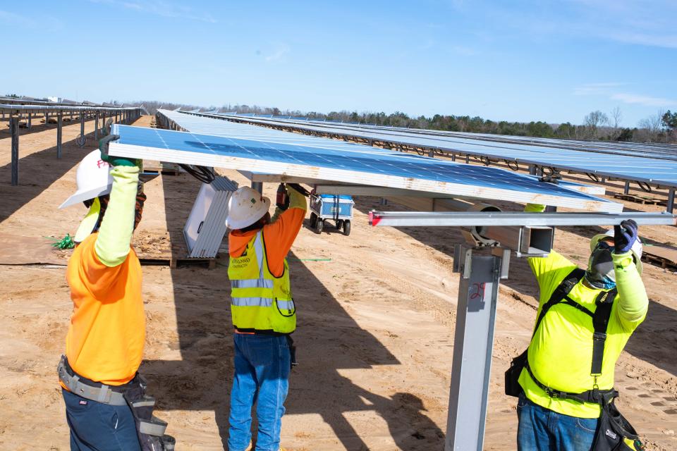 Gulf Power construction workers install a solar panel at the Blue Indigo Solar Energy Center in Jackson County on Jan 7, 2020.