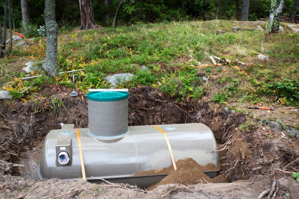 New septic tank being installed in ground.